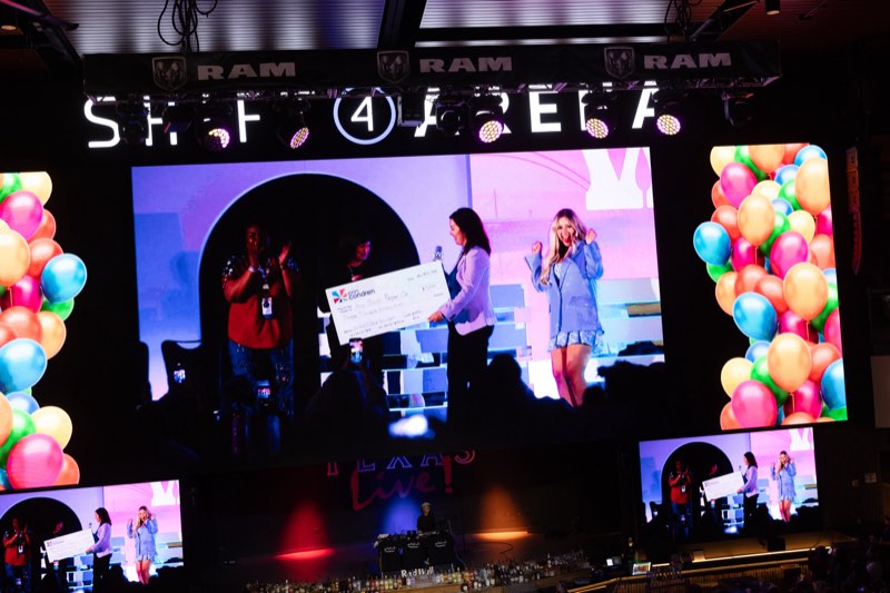 A $5,000 grant check presented on the arena stage at Texas Live!